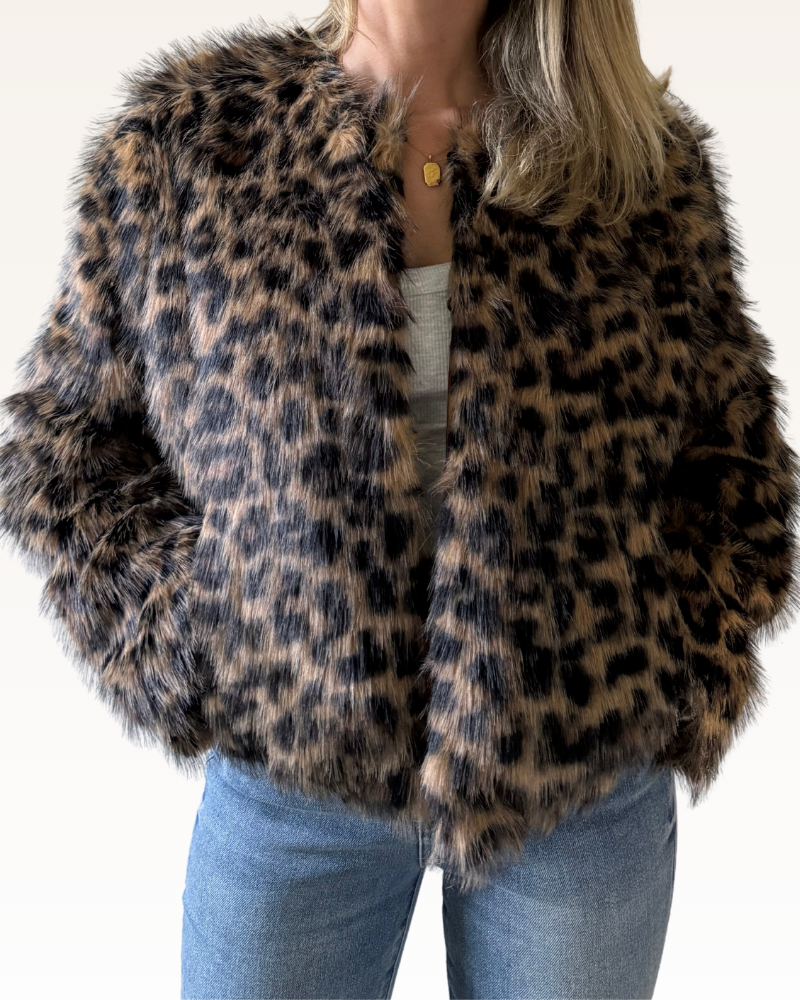 Leopard print faux fur coat worn by a person on a white background