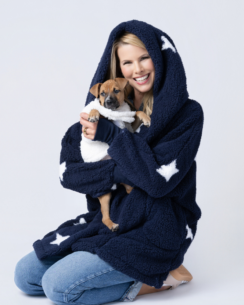 person wearing sherpa in navy with starts holding dog wearing white sherpa pet jacket