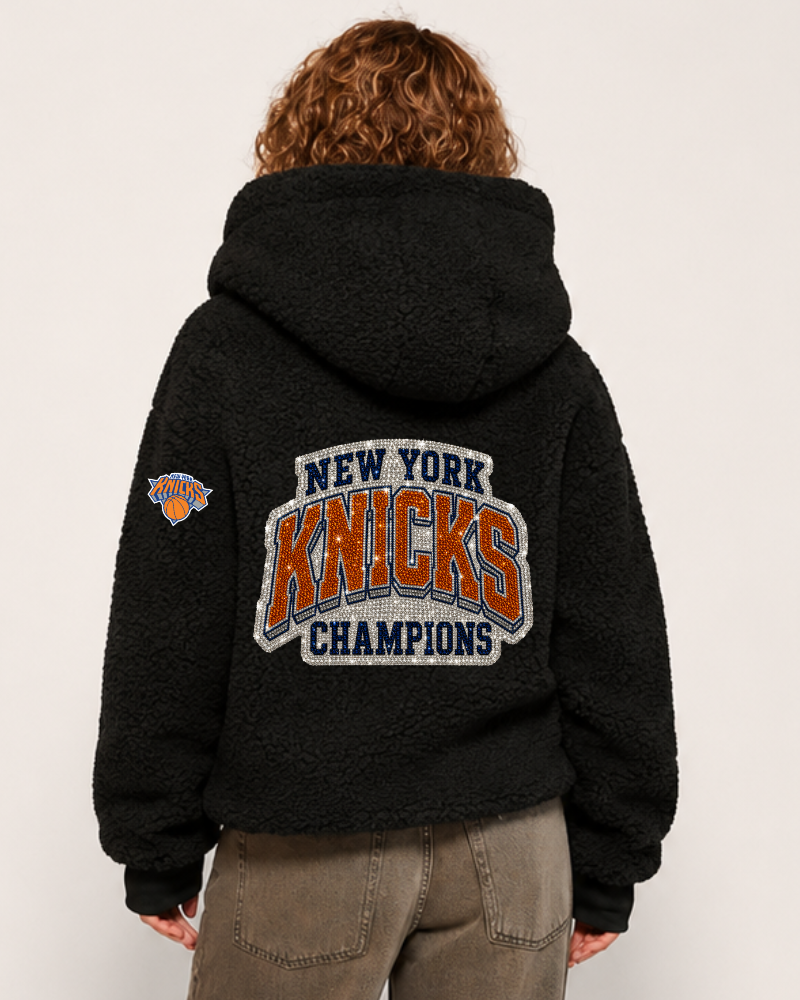 Person wearing a black hoodie with 'New York Knicks Champions' text on the back.