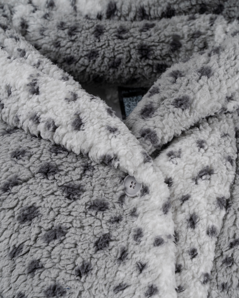 Close-up of sherpa gray lounger with snow leopard pattern