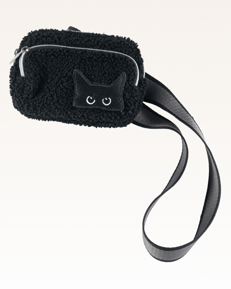 Black fluffy pouch with cat face design and strap on a white background