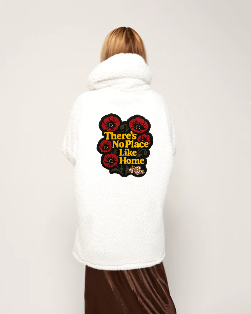 Person wearing a white hoodie with a graphic design on the back against a plain background