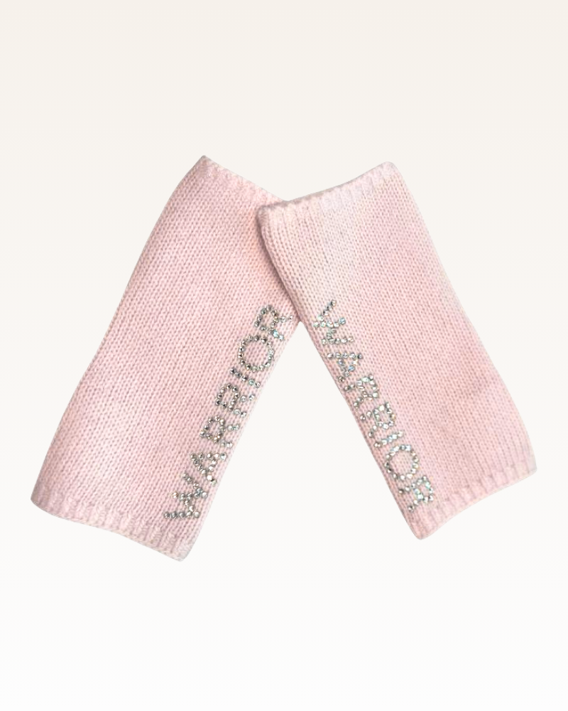 Pair of pink knitted leg warmers with 'Warrior' branding on a white background