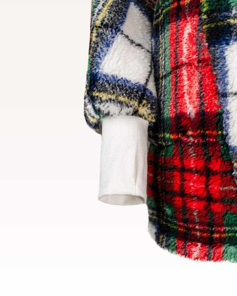 Close-up of a colorful plaid sherpa lounger on a white background