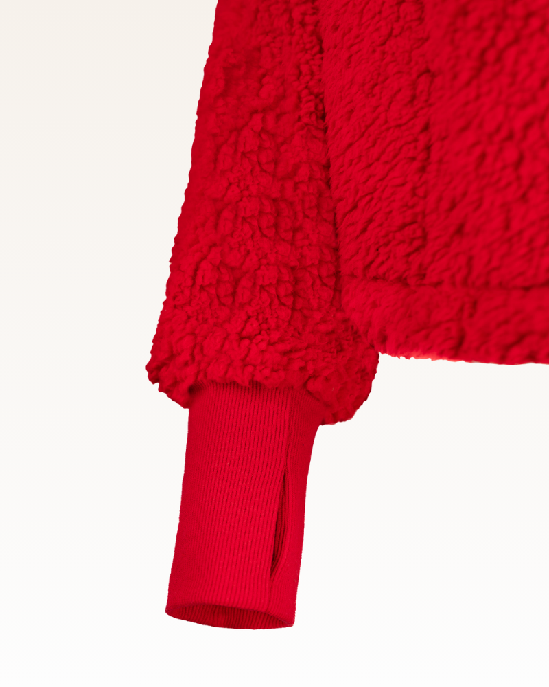 Close-up of a red textured sweater on a white background