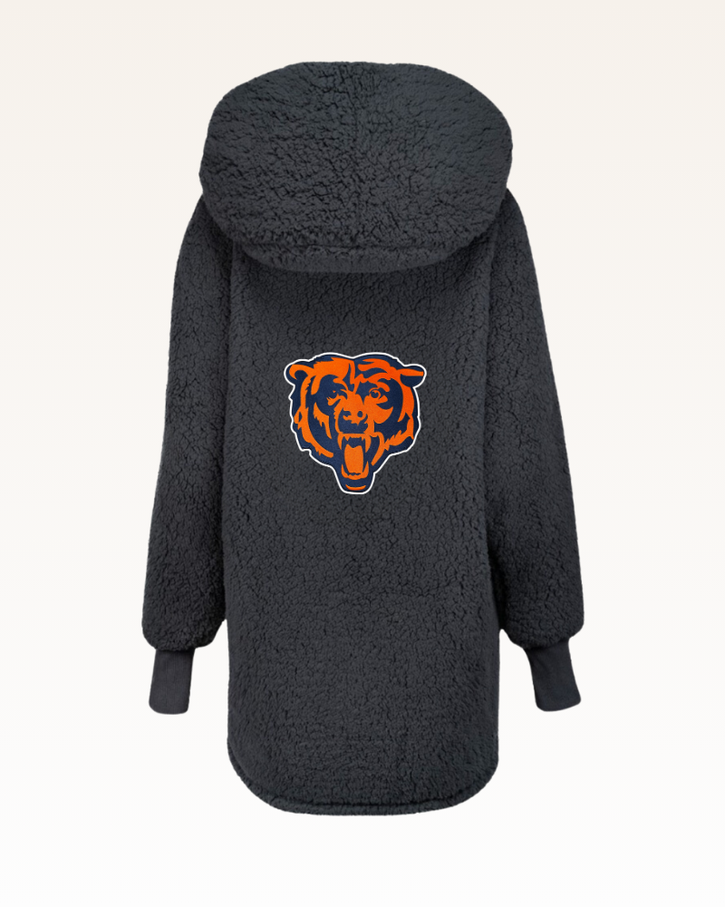 black sherpa jacket with a bear logo on the back against a white background