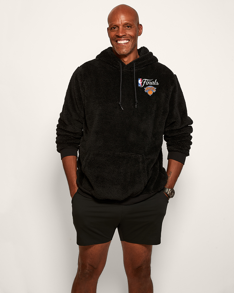 Man wearing a black hoodie with a logo on a white background