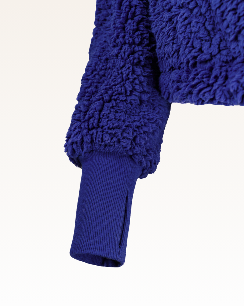 Close-up of a blue textured garment with a white background