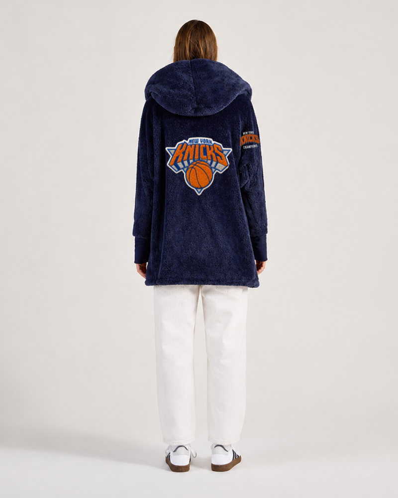 Person wearing a navy blue lounger with a logo on a white background