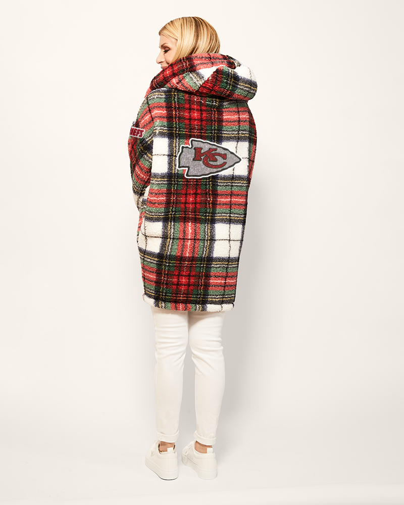 person wearing plaid sherpa lounger with Kansas City Chiefs logo and chiefs patch on the left arm