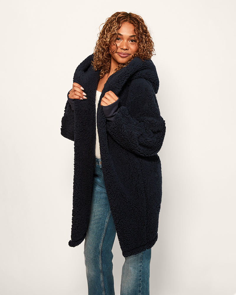 Woman wearing a dark blue coat on a white background