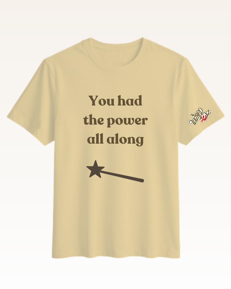 Beige t-shirt with motivational quote and wand design on a white background