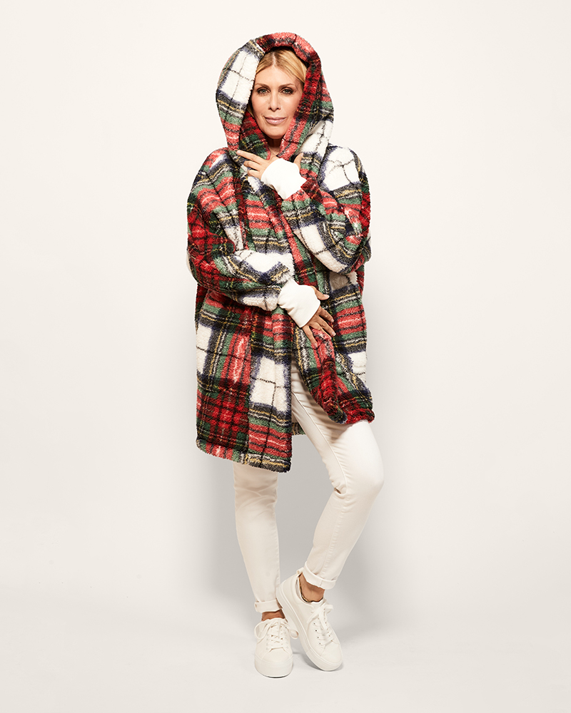 Person wearing a plaid coat with a hood on a white background