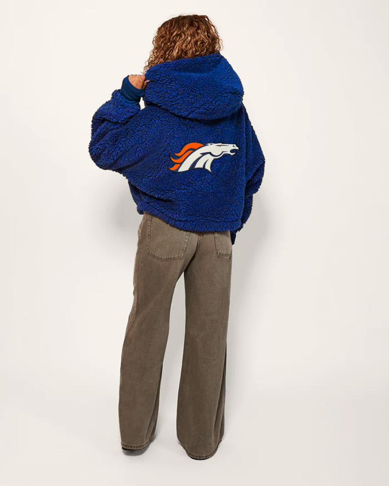 person wearing blue sherpa cropped lounger with bronco logo on the back
