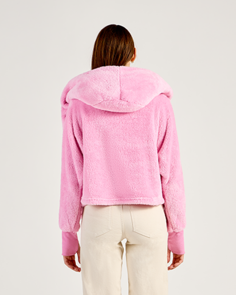 Person wearing a pink hoodie on a plain background|Model: 5'11" in size XS/S