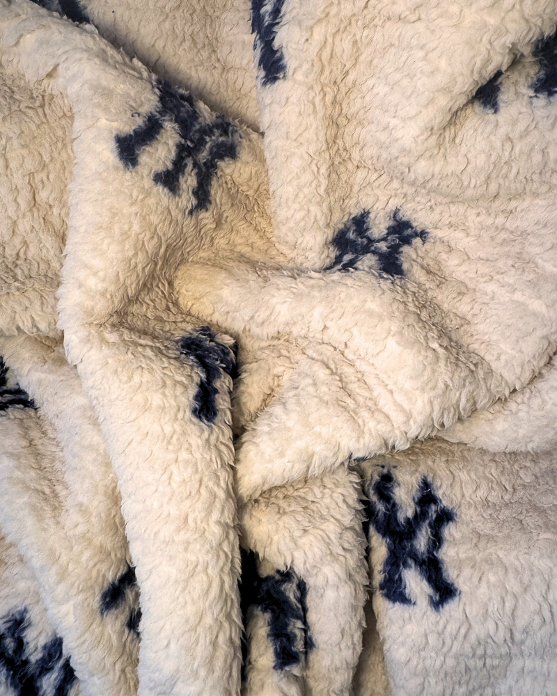 Close-up of a textured fabric with black yankees patterns