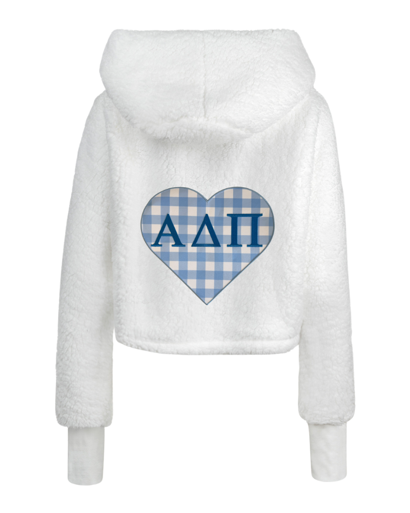 White sherpa fleece cropped hoodie with a blue and white gingham heart graphic on the back featuring the Greek letters Alpha Delta Pi.