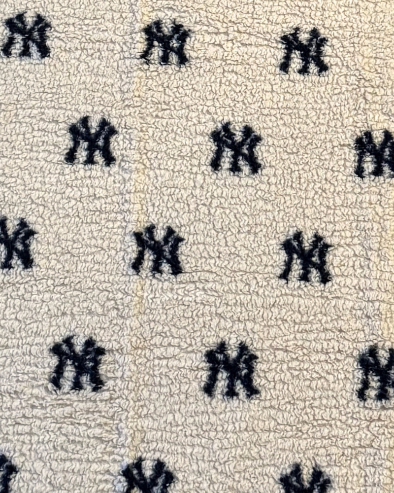 Pattern of black symbols on a textured beige background