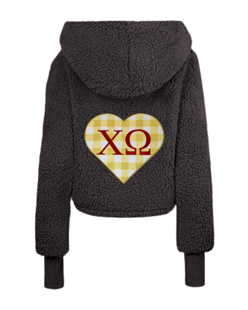 A dark gray sherpa fleece cropped hoodie shown from the back, featuring a yellow and white gingham heart graphic with red Greek letters 'XΩ' in the center.