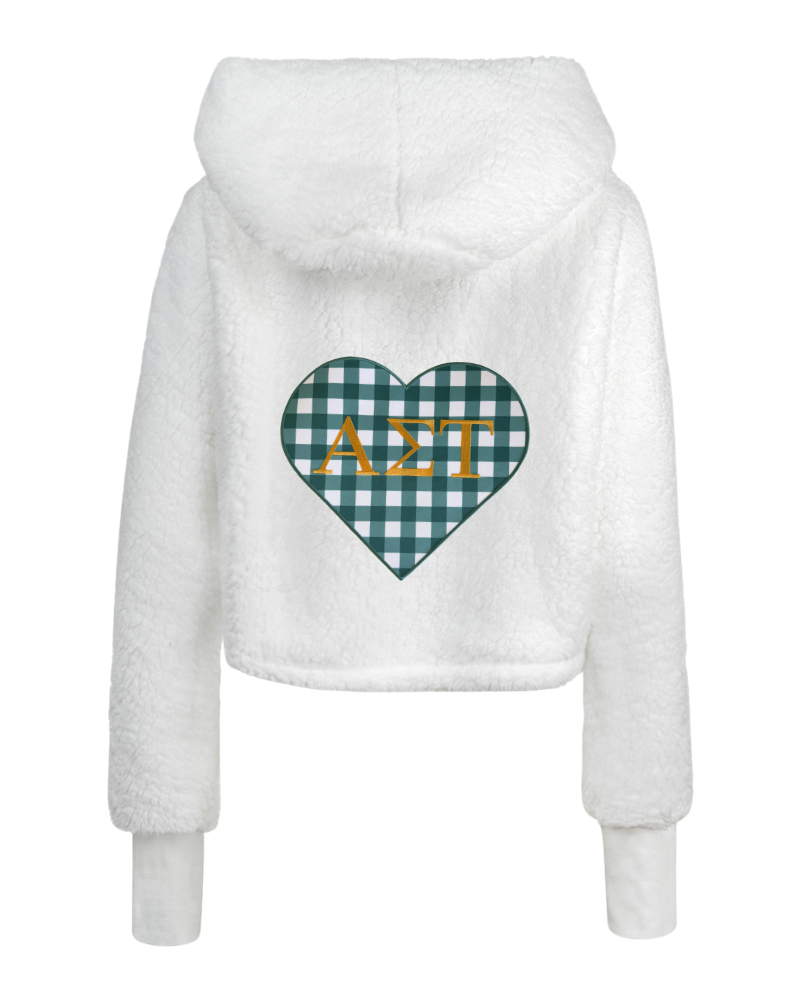White sherpa fleece cropped hoodie with a green and white gingham heart graphic on the back featuring gold Greek letters Alpha Sigma Tau.