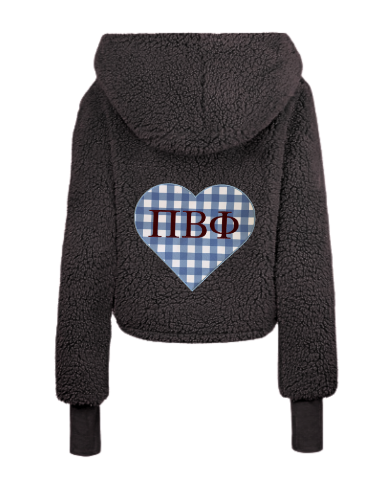 A black sherpa fleece cropped hoodie shown from the back, featuring a blue and white gingham heart graphic with the Greek letters 'Pi Beta Phi' in red.