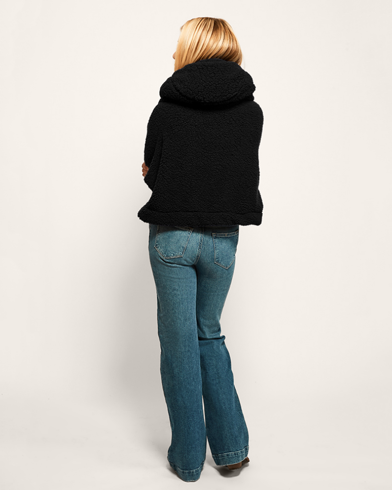 woman wearing black cropped sherpa lounger and jeans