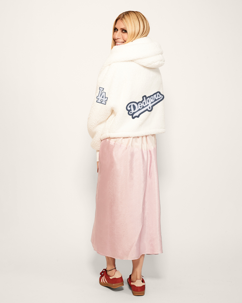 Person wearing a white hoodie with 'Dodgers' logo on back and sleeve