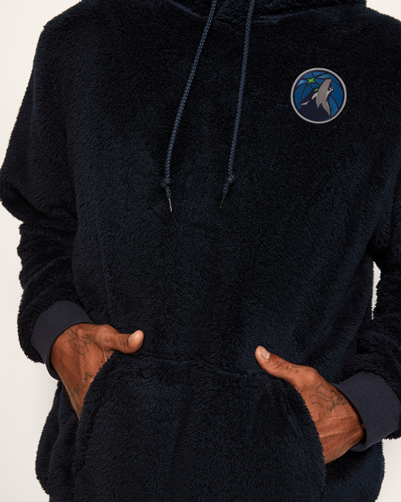 navy fleece hoodie with a timberwolves logo on the chest against a white background