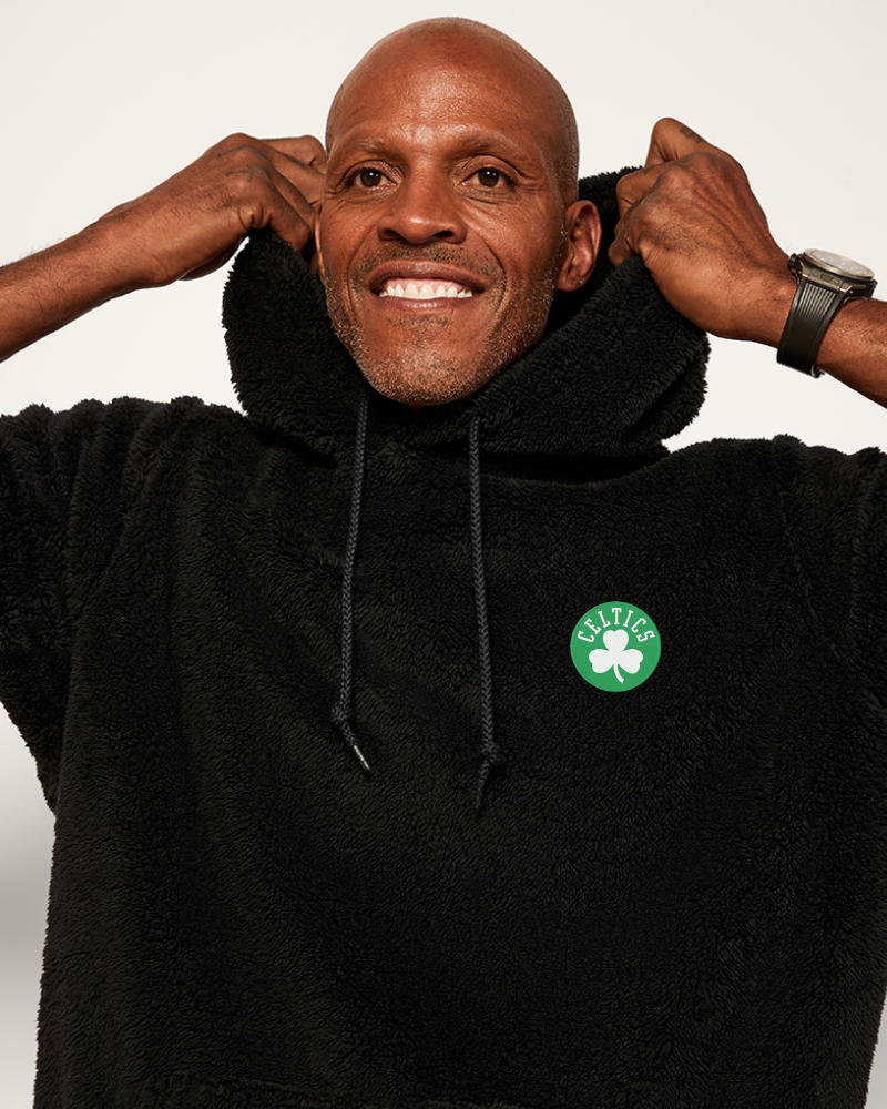 Man wearing a black hoodie with a Celtics logo on a white background