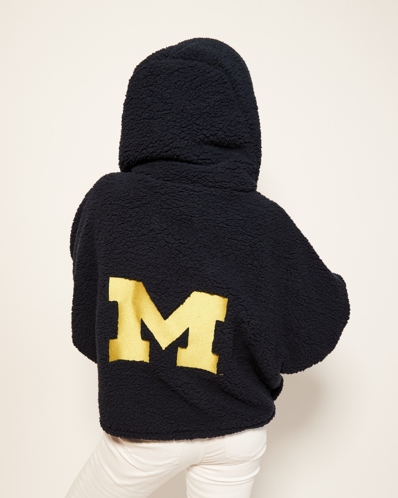 navy sherpa lounger hoodie with a gold university of michigan 'M' on the back against a white background