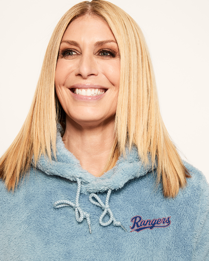 Woman wearing a blue hoodie with a texas 'Rangers' logo on a light background