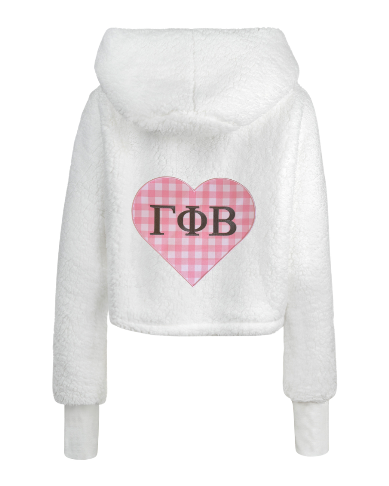 White sherpa fleece cropped hoodie with a pink gingham heart graphic on the back featuring the Greek letters Gamma Phi Beta in black.