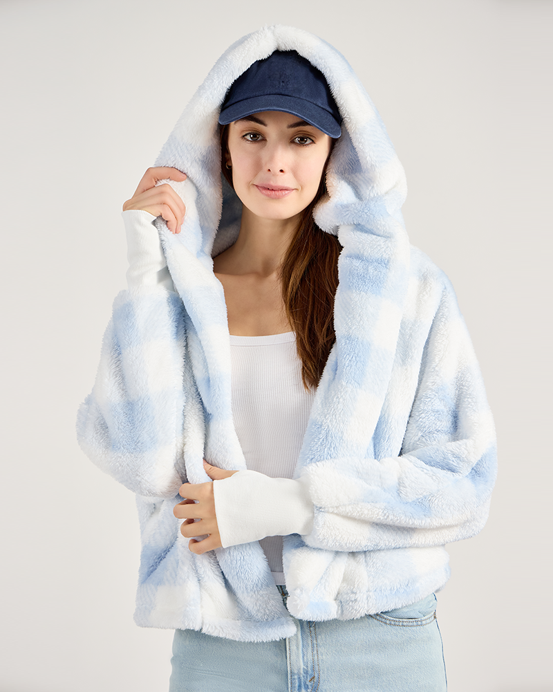 Woman wearing a white and blue plaid lounger with a hood against a plain background|Model: 5'11 in size XS/S