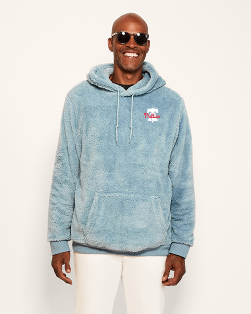 Man wearing a blue hoodie with a philadelphia phillies logo on a white background