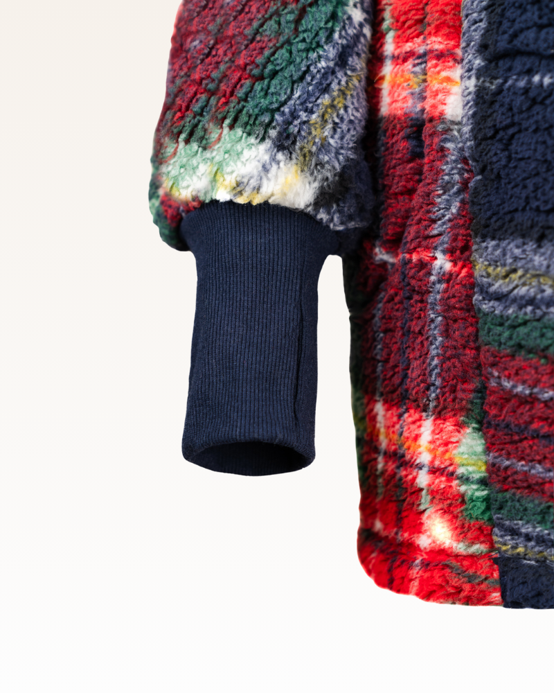 Close-up of a colorful plaid fabric with a blue ribbed texture.