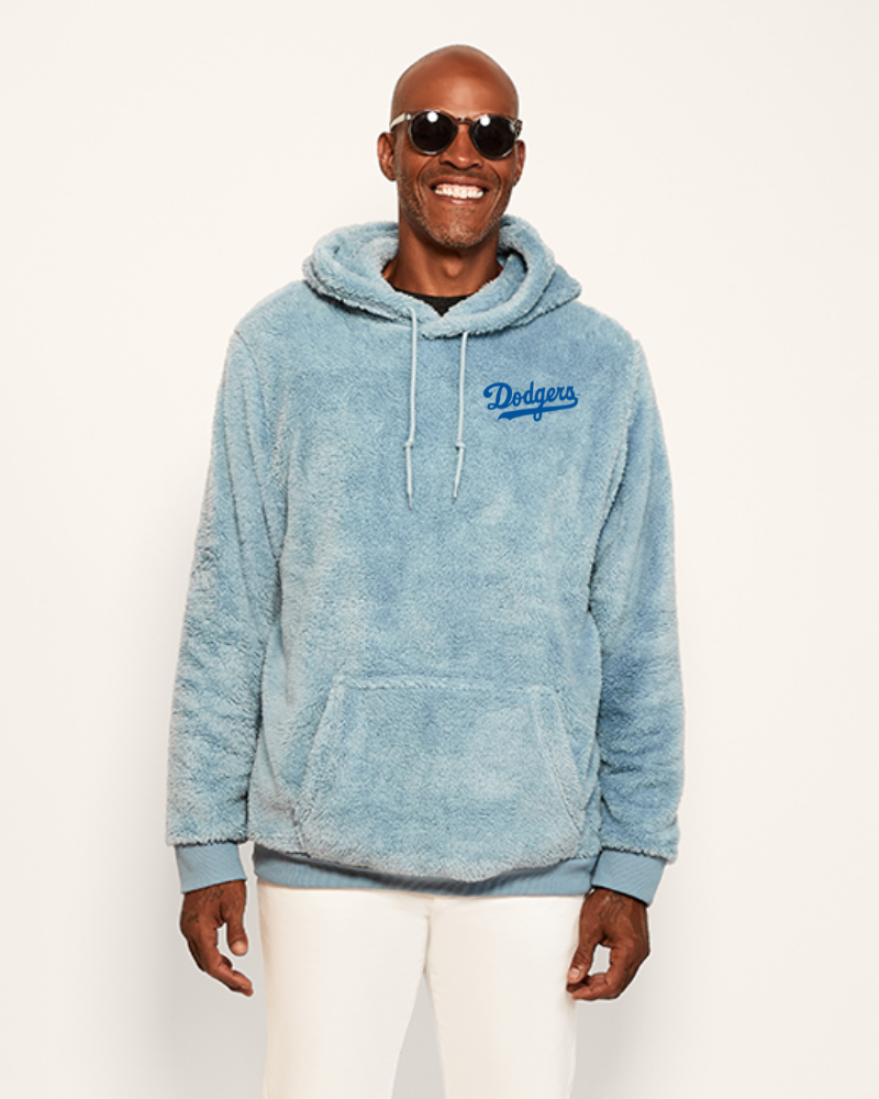 Man wearing a blue hoodie with a los angeles 'Dodgers' logo on a white background