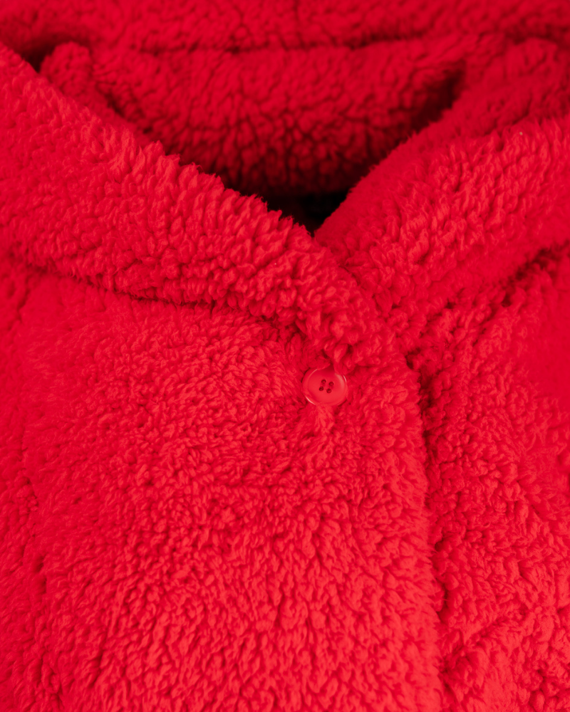 Close-up of a red textured fabric with buttons