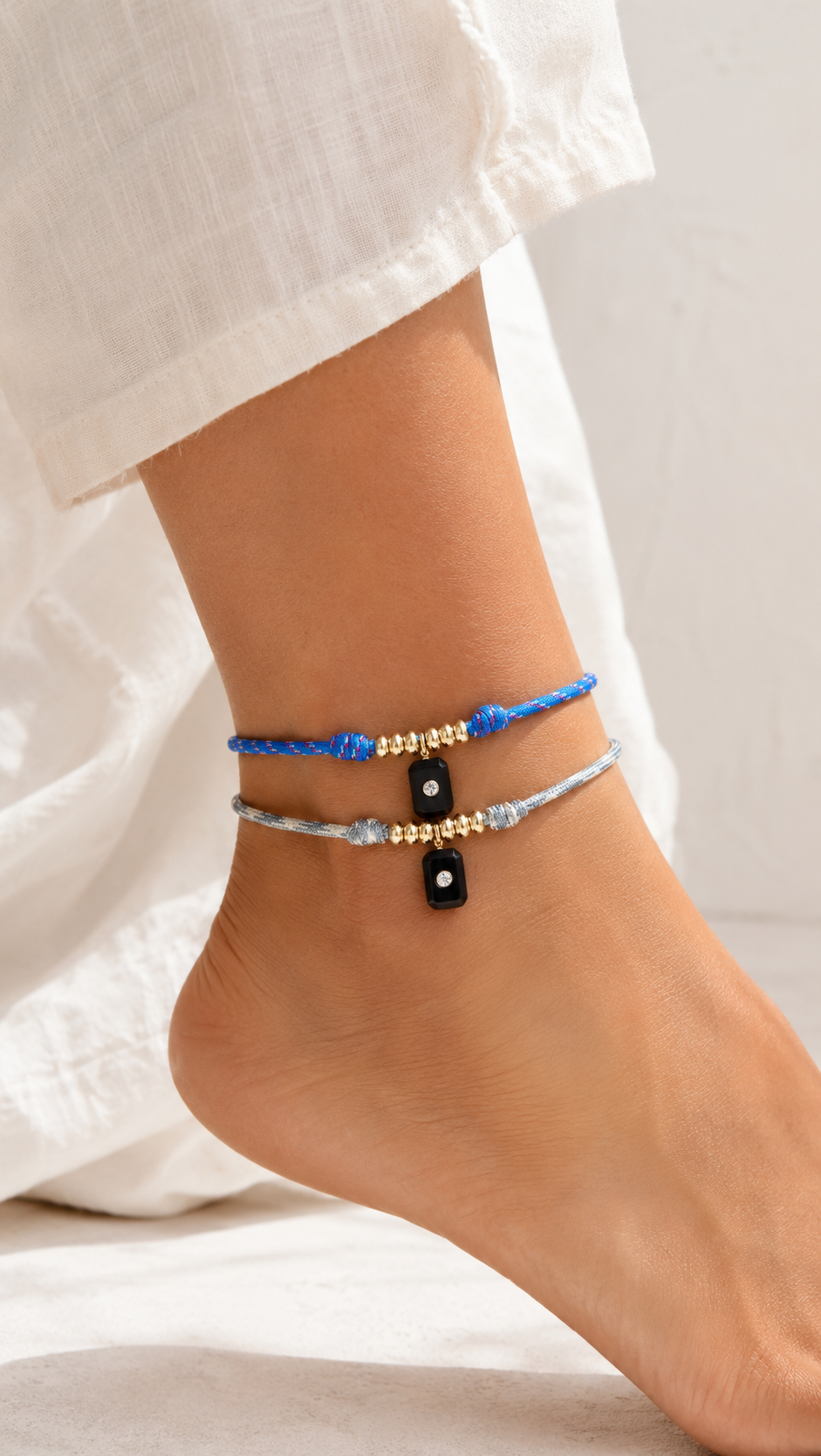 Anklets on a person's ankle with a blurred background