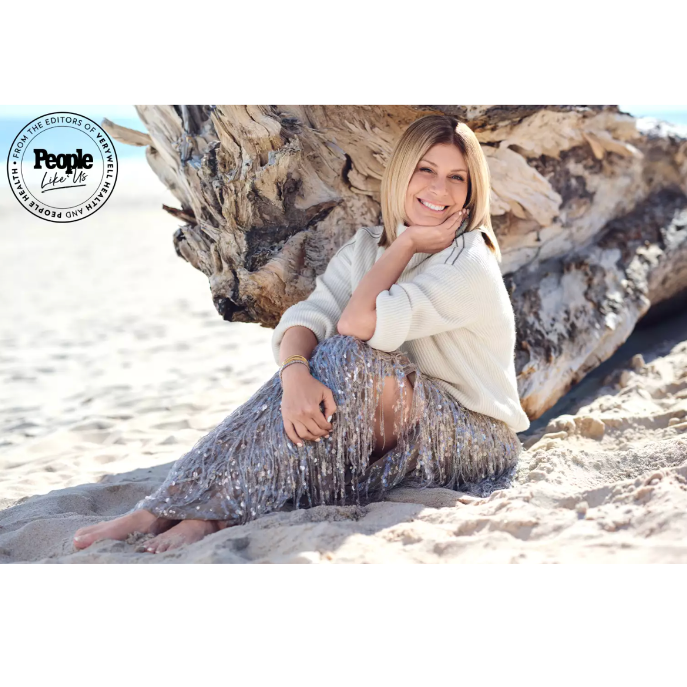 jill martin poses for people magazine on the beach wearing a sweater and sequin skirt