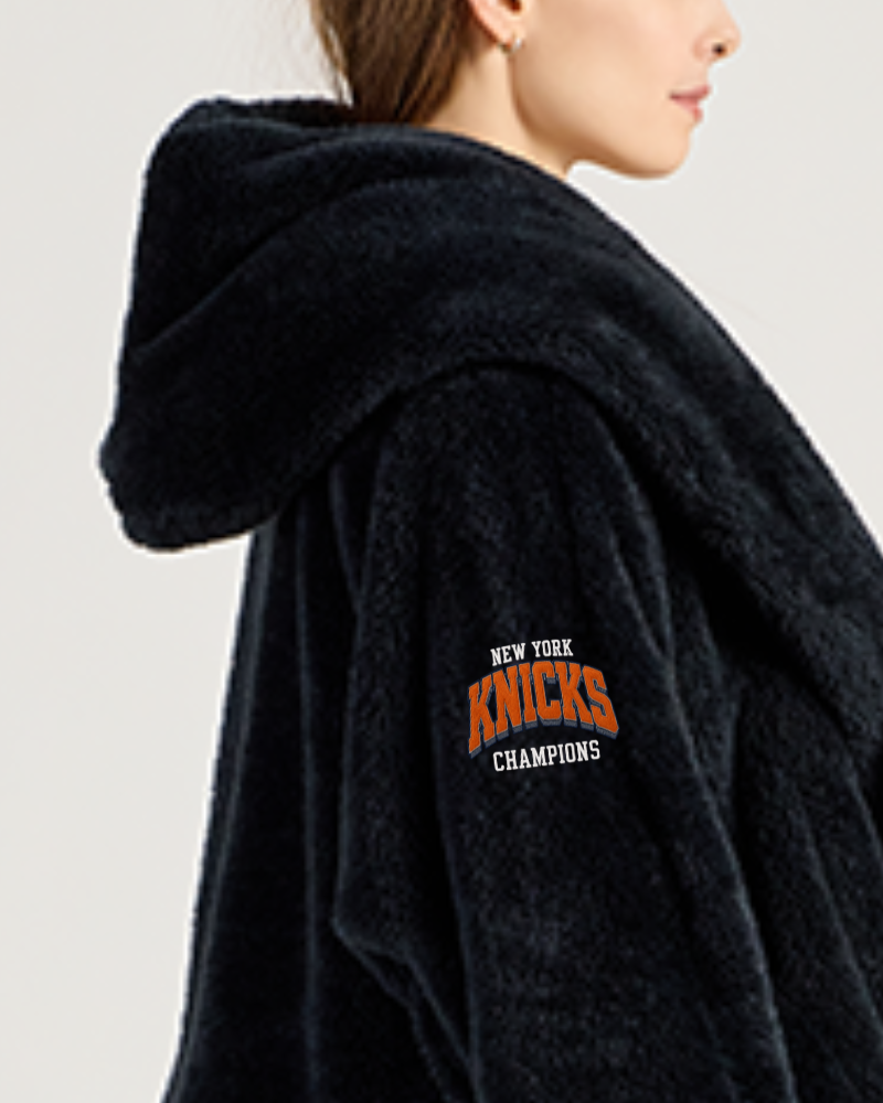 Black lounger with 'New York Knicks Champions' text on a plain background