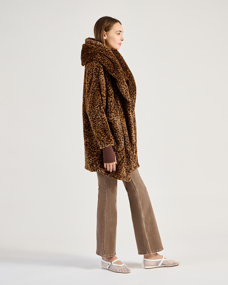 Woman wearing a brown teddy coat on a white background