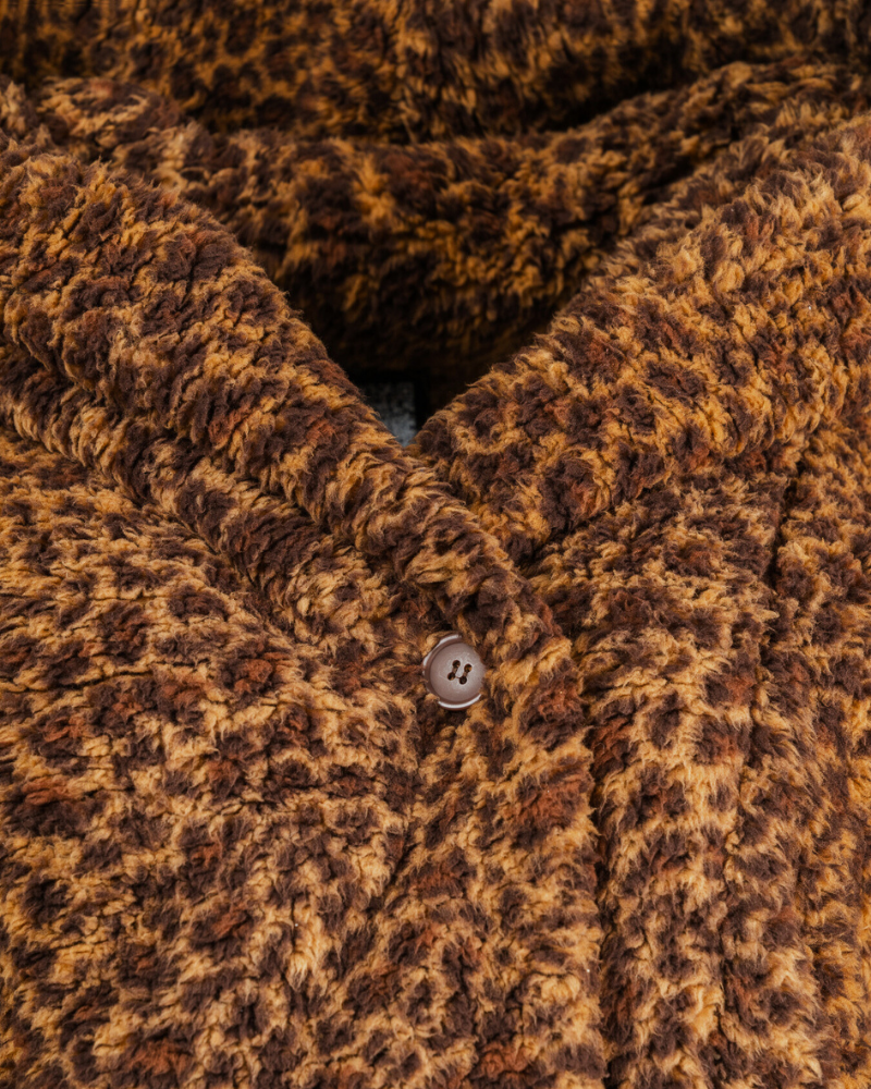 Close-up of a brown textured fabric with a button