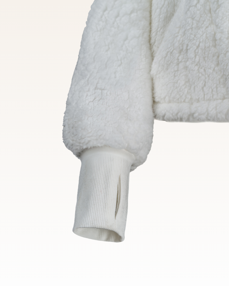 Close-up of a textured white garment with a white background