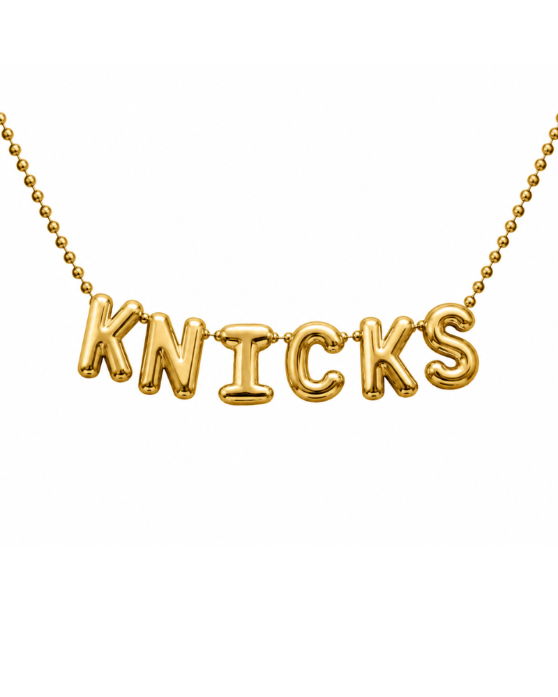 Gold 'KNICKS' necklace on a white background