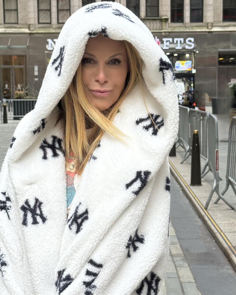 Person wearing a white coat with black patterns, standing on a city street.|Jill: 5'6" in size XS/S