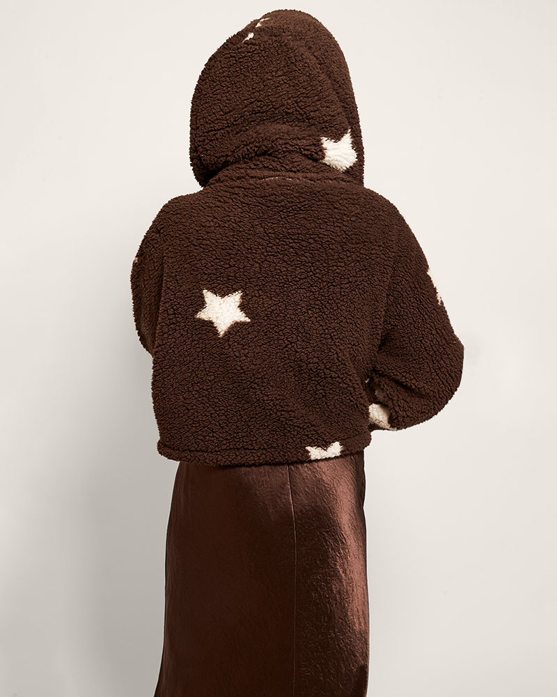 Brown fleece jacket with star patterns on a plain background