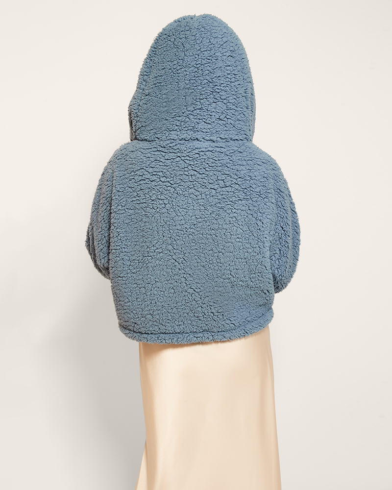 Blue fleece hooded jacket on a personagainst a light background