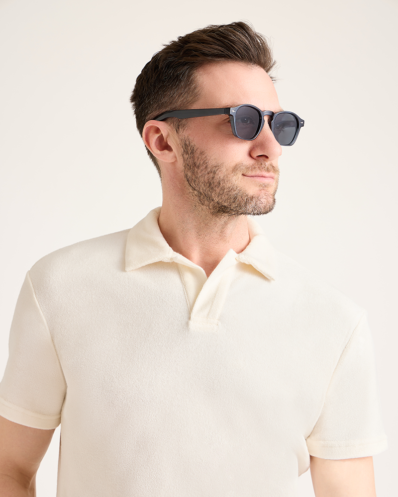 Man wearing sunglasses and a light-colored polo shirt against a plain background|Model: 5'11" wearing size L