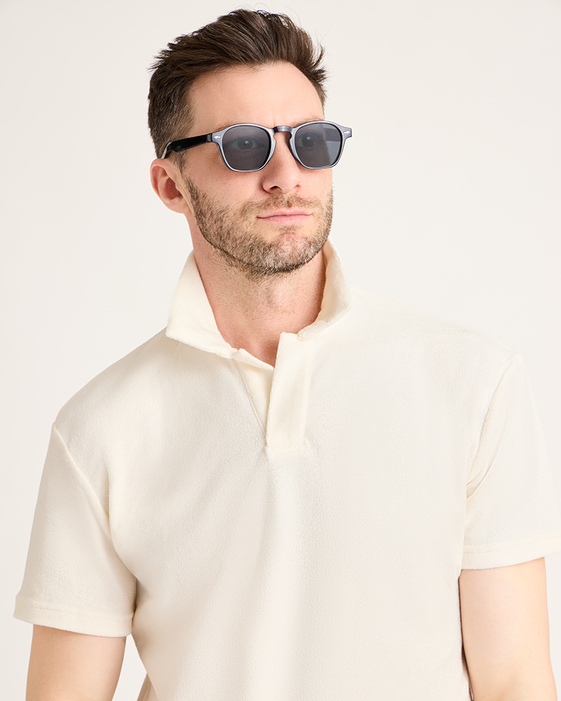 Man wearing sunglasses and a light-colored shirt against a plain background|Model: 5'11" wearing size L