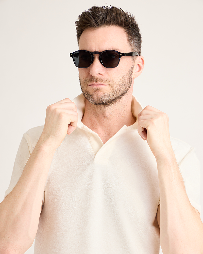 Man wearing sunglasses and a beige shirt against a light background|Model: 5'11" wearing size L